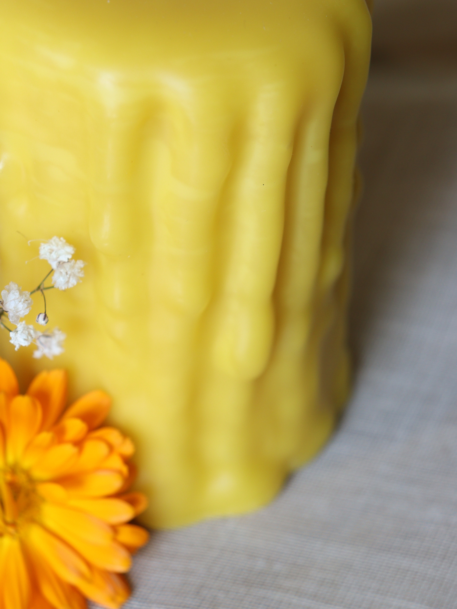 Close-up of a dripped beeswax cappings pillar