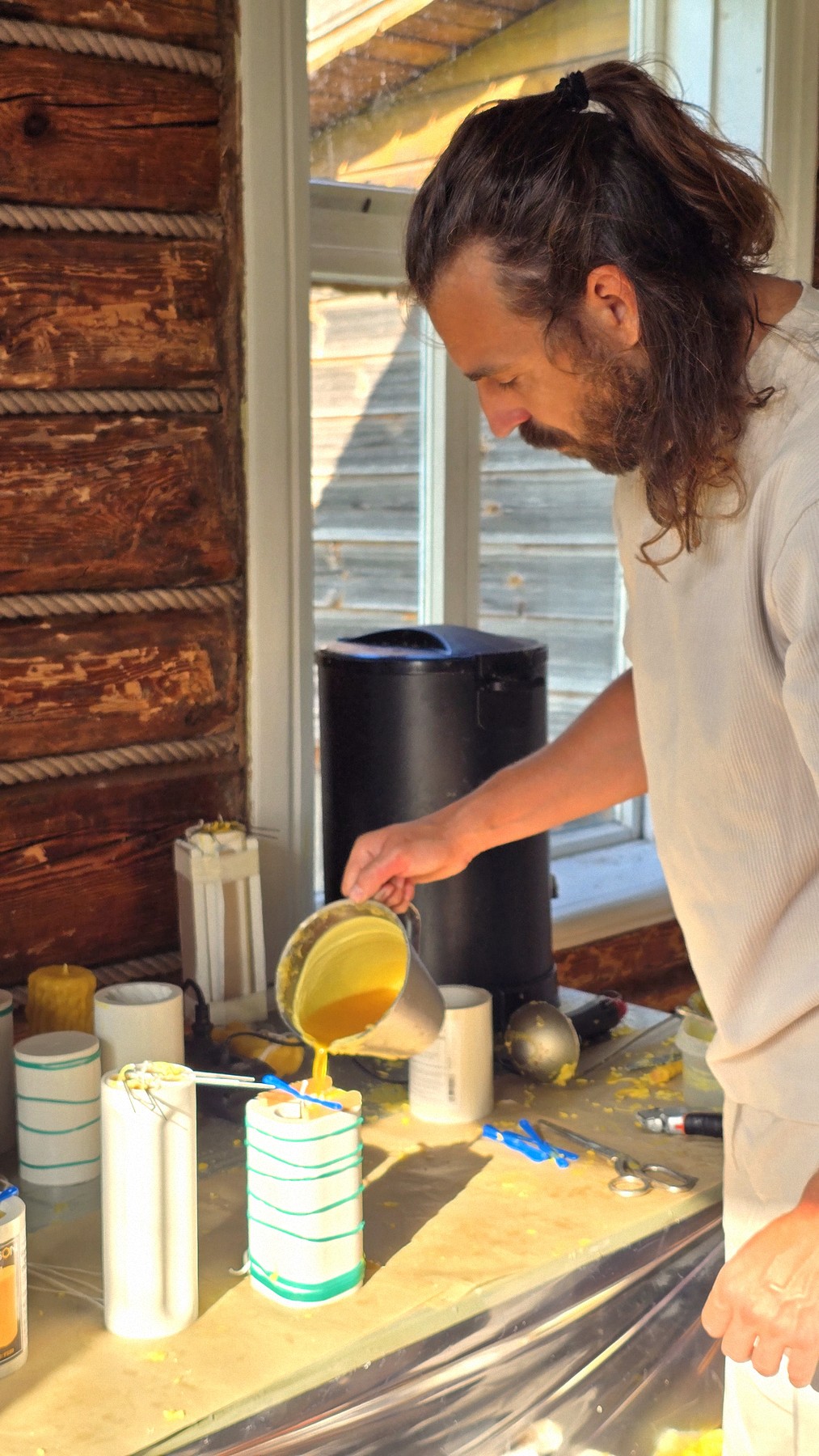 Pouring beeswax in the studio